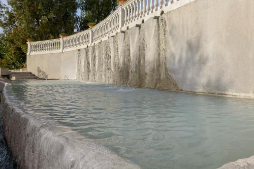 a pool of water next to a concrete wall at Hotel Terme Capasso in Contursi