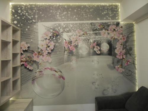 a room with a wall decorated with flowers and vases at Lovely Apartment 2 Room Palas Mall in Iaşi