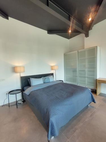 a bedroom with a large bed and a table at Sky Loft in Iaşi