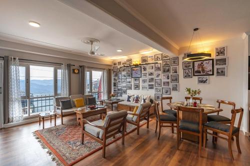 a living room with a table and chairs at Zostel Homes Shimla in Shimla