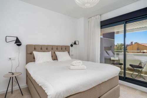 a bedroom with a large bed and a large window at Modern flat near Los Alamos beach Ref 22 in Torremolinos