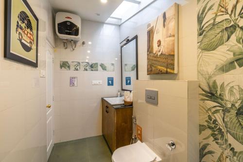 a bathroom with a toilet and a sink at Zostel Homes Shimla in Shimla