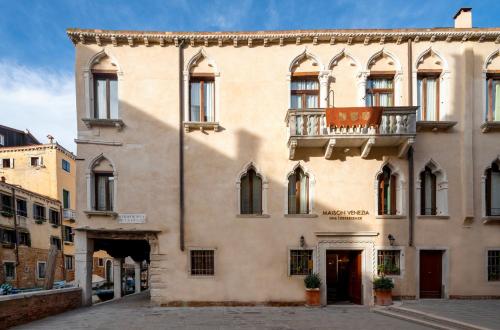 a large building with a balcony on a street at Maison Venezia | UNA Esperienze in Venice
