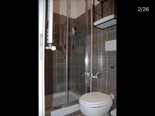 a bathroom with a toilet and a glass shower at fabio rooms 102 in Rome