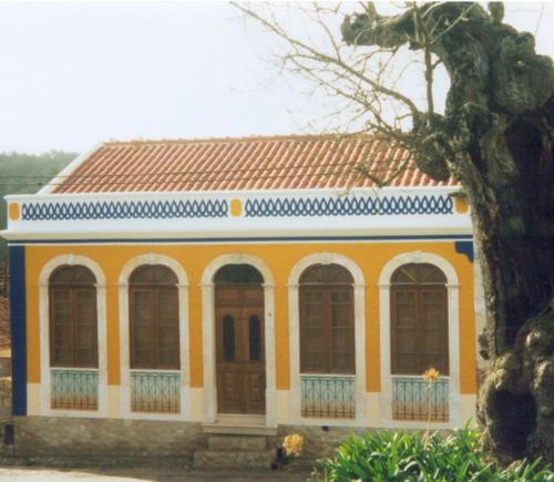 żółto-niebieski budynek z czerwonym dachem w obiekcie RC - Alcobaca Villa Alcobaca w mieście Alqueidão