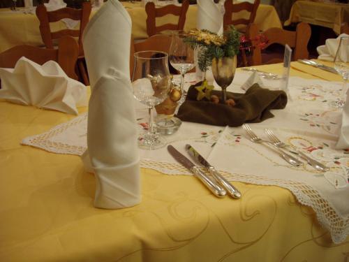 a table with a white table cloth and silverware at Hotel Restaurant Landhaus Köhle in Neukirch