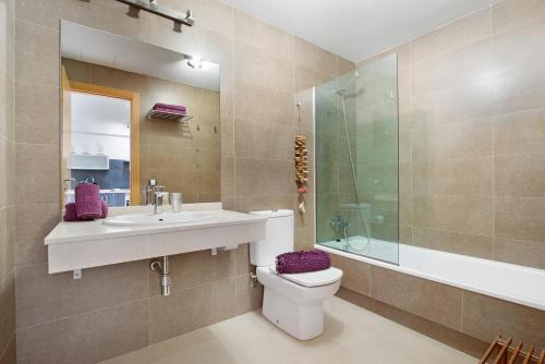 a bathroom with a sink and a toilet and a shower at Apartamento Nautilus sea view in El Cotillo