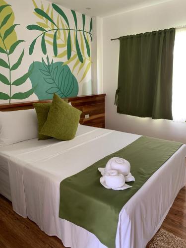 a bedroom with a bed with a towel on it at ROYAL SUITES - PORT BARTON in San Vicente