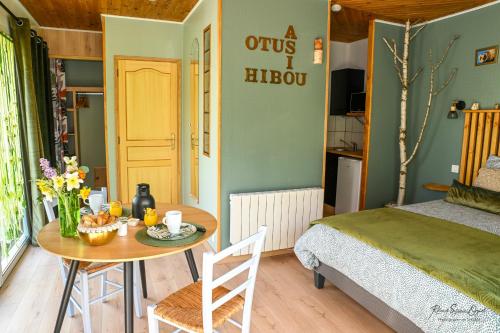 a bedroom with a table and a bed and a table and chairs at CASA UPUPA in Montreuil