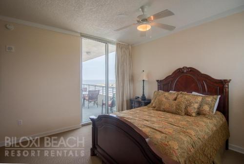 een slaapkamer met een bed en een raam met uitzicht bij Ocean Club 701 in Biloxi