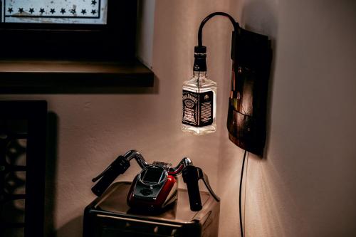 a light on a wall with a bottle on it at Jantarvia Car Museum , Pasja i Wypoczynek Noclegi z Klimatem in Jantar