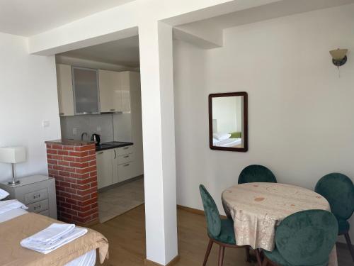 a kitchen and dining room with a table and chairs at Guest house Villa Slavica in Sveti Stefan