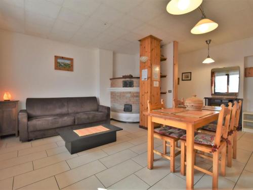 ein Wohnzimmer mit einem Tisch und einem Sofa in der Unterkunft Apartment Santa Lucia-3 by Interhome in Valdisotto