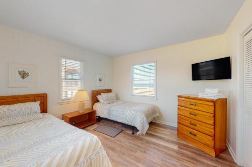 a bedroom with two beds and a flat screen tv at Windy Dunes 138 in Avon