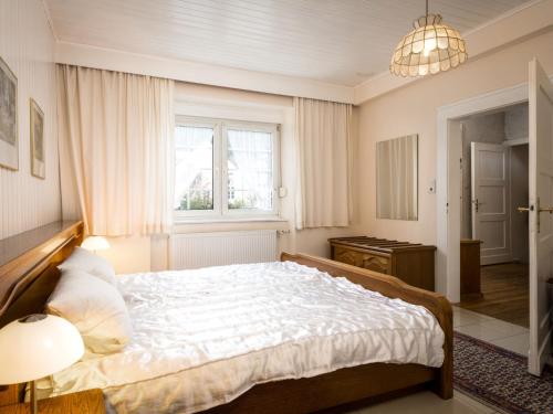 a bedroom with a large bed and a window at Holiday Home Häuschen by Interhome in Traben-Trarbach