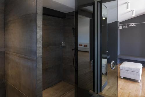 a shower with a glass door in a bathroom at Palacio Julio Hotel in Puebla