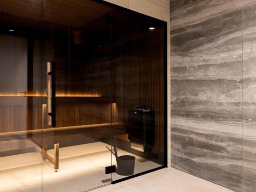a room with a glass wall with a bench and a wall at Holiday Home Citta Romana-1 by Interhome in Hellevoetsluis