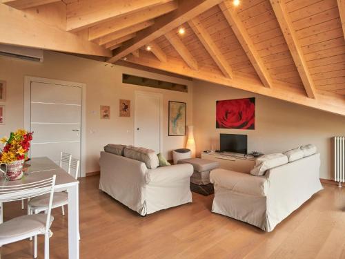 a living room with white furniture and a table at Villa Giuseppina by Interhome in Besozzo