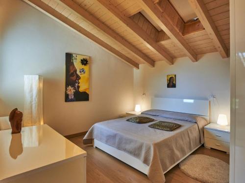 a bedroom with a bed and a wooden ceiling at Villa Giuseppina by Interhome in Besozzo