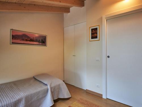 a bedroom with a bed and a closet at Villa Giuseppina by Interhome in Besozzo