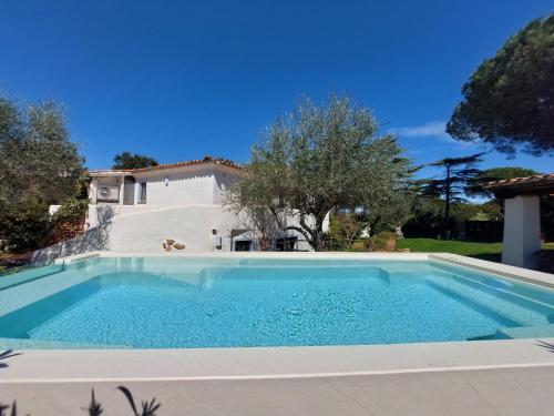 a swimming pool in front of a house at Holiday Home Omer by Interhome in San Teodoro