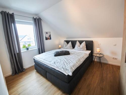 a bedroom with a bed and a large window at Apartment Landliebe by Interhome 