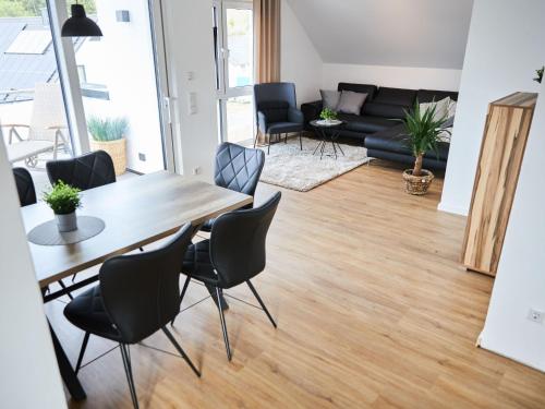 a living room with a table and chairs and a couch at Apartment Landliebe by Interhome in Helden