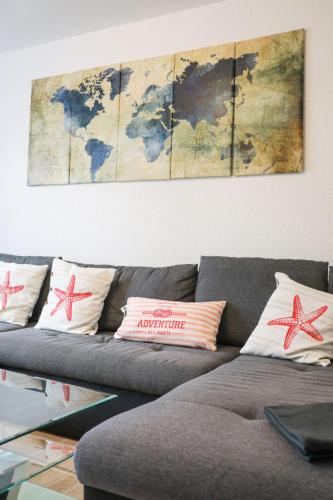 a living room with a couch with a map on the wall at Apartment Am Ostedeich-2 by Interhome in Oberndorf