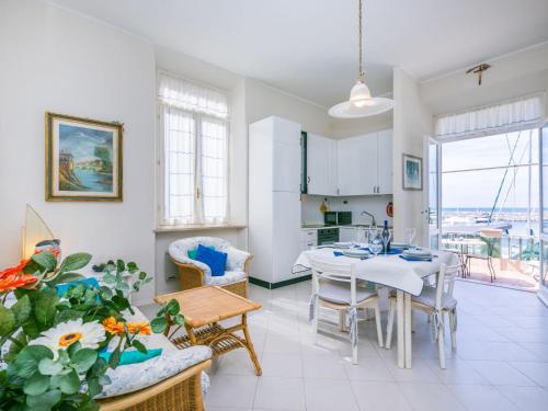 a kitchen and living room with a table and chairs at Apartment Ponente N-2 by Interhome in San Vincenzo