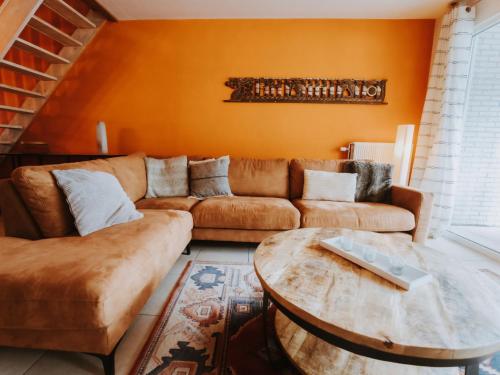 a living room with a couch and a table at Apartment The Horseshoe with parking by Interhome in Bredene
