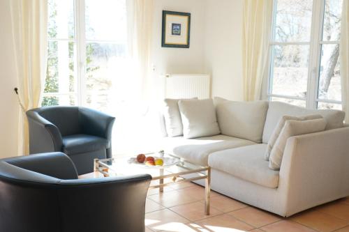 a living room with a couch and a chair at Ferien in Himmelpfort in Himmelpfort