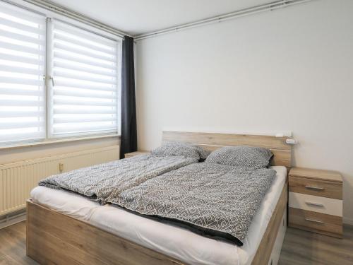 a bedroom with a bed and a large window at Apartment Am Ostedeich-1 by Interhome in Oberndorf