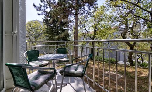 a table and chairs on a balcony with a view at Modern Apartment Selce in Selce