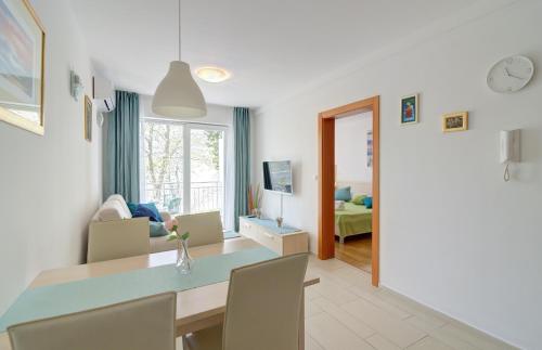 a kitchen and living room with a table and chairs at Modern Apartment Selce in Selce