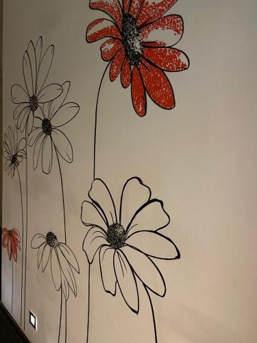 a drawing of flowers on a wall at Hotel Aan Zee in De Panne