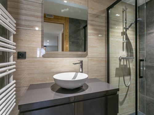 a bathroom with a sink and a glass shower at Appartement La Clusaz, 2 pièces, 4 personnes - FR-1-437-89 in La Clusaz