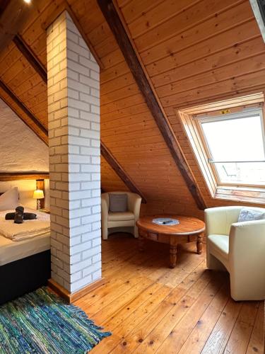a bedroom in a attic with a bed and a table at Zum Alten Schulhaus in Burg