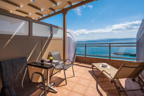 a balcony with a table and chairs on a ship at Minos Boutique Hotel in Agia Galini