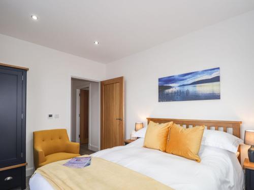 a bedroom with a bed and a chair at Firthview in Nairn
