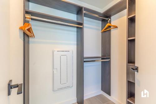 a walk in closet with a glass door at Downtown Miami Condos by Lua Host in Miami
