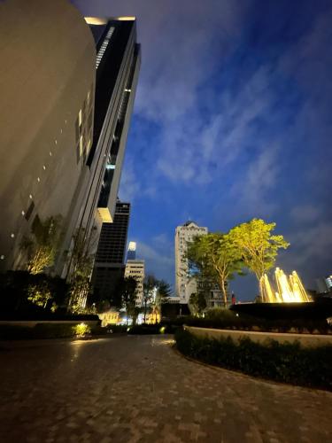 a city street at night with tall buildings at Lucentia residence T1 in Kuala Lumpur