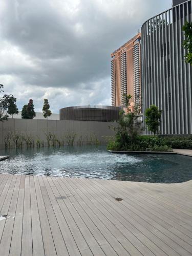 a pool of water in front of a building at Lucentia residence T1 in Kuala Lumpur
