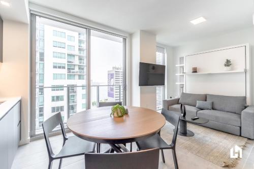 a kitchen and living room with a table and chairs at Downtown Miami Condos by Lua Host in Miami