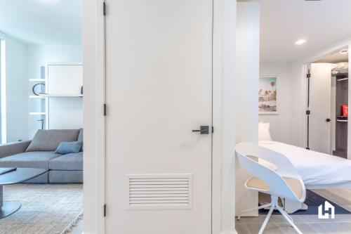 a white room with a couch and a table and a chair at Downtown Miami Condos by Lua Host in Miami
