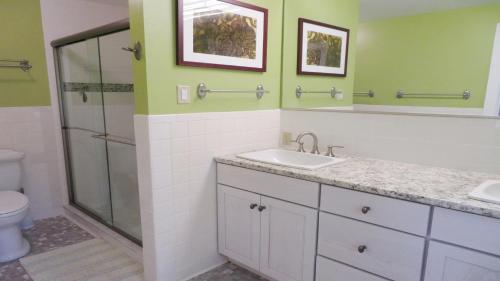 a bathroom with a sink and a shower at 160 Long Pond Drive Harwich Cape Cod - Old Camp in Harwich