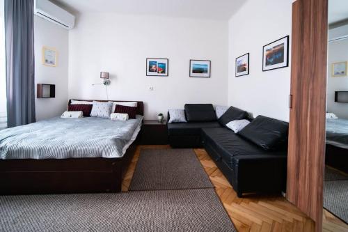 a living room with a bed and a couch at Free public parking BumbleBee Apartment 4ppl AC FastNet TV in Budapest