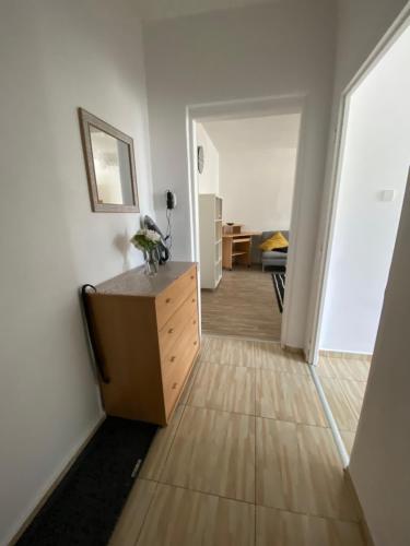 a living room with a dresser and a hallway at Apartment city centrum in Nitra