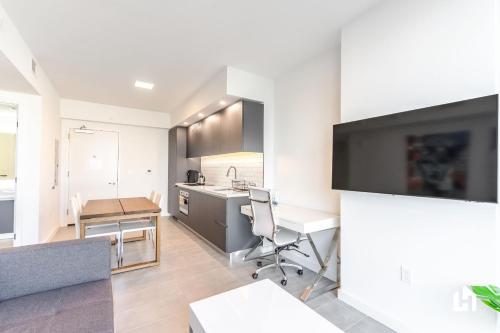 a kitchen with a desk and a table in a room at Downtown Miami Condos by Lua Host in Miami