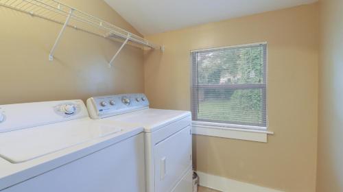 a laundry room with a washing machine and a window at House on Beverly in Biloxi