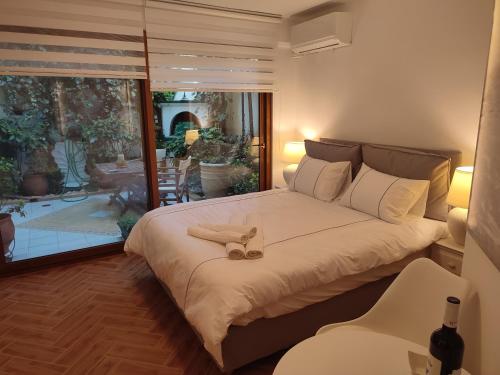 a bedroom with a bed with a pair of shoes on it at Studio Apollonia in Alexandroupoli